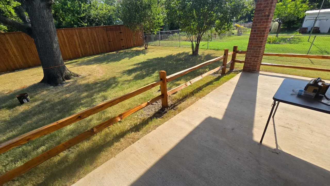 8 ft tall western red cedar board on board with double trim. Cedar split rail fence around the concrete patio. Fences stain with Golden cedar color stain. — Addison