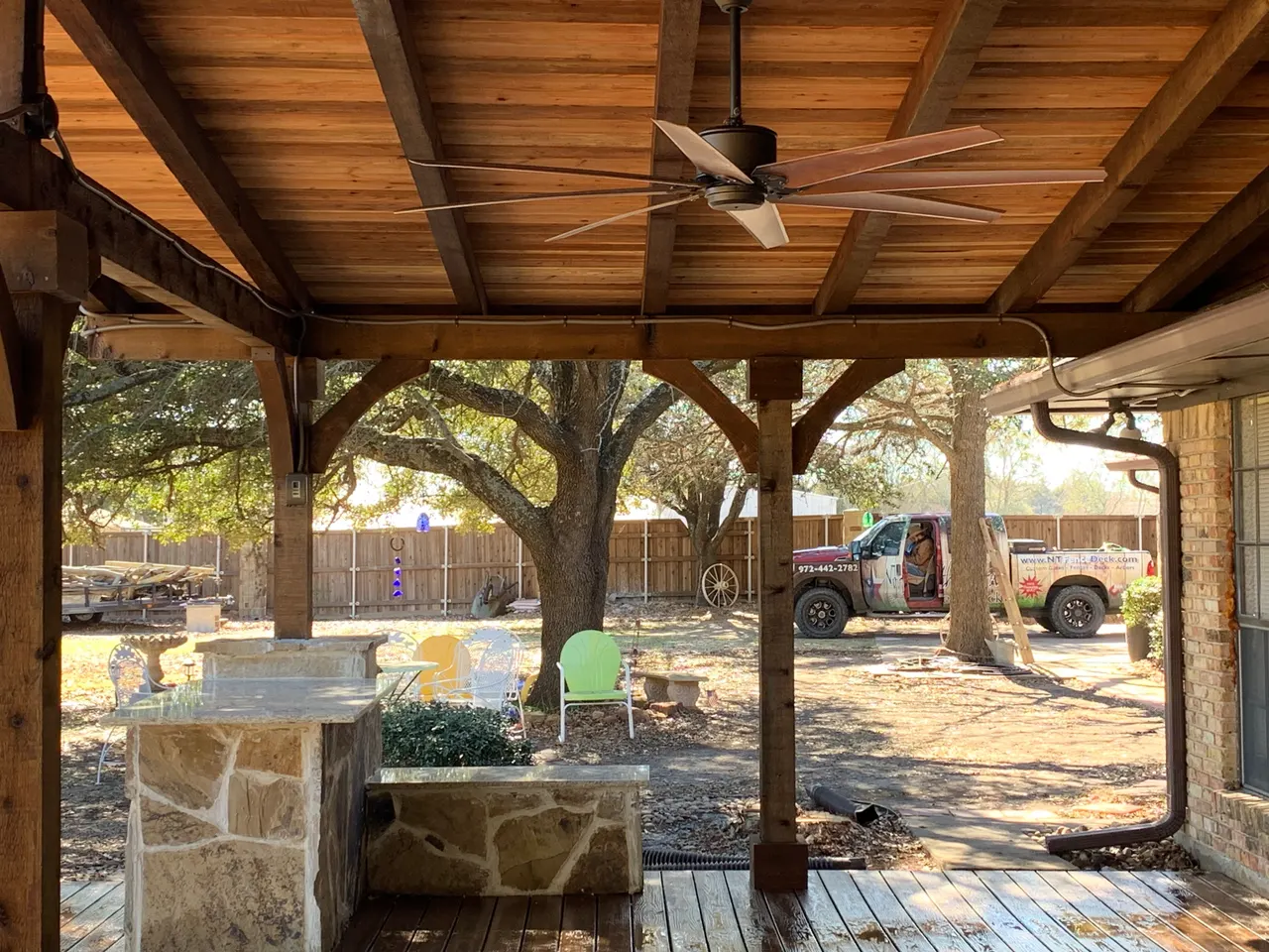 Western red cedar gable style patio with a composite deck. Oklahoma flagstone bars and benches with granite countertops. outdoor kitchen — Plano