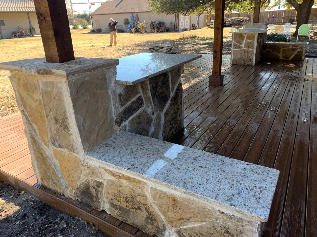 Western red cedar gable style patio with a composite deck. Oklahoma flagstone bars and benches with granite countertops. outdoor kitchen — Plano